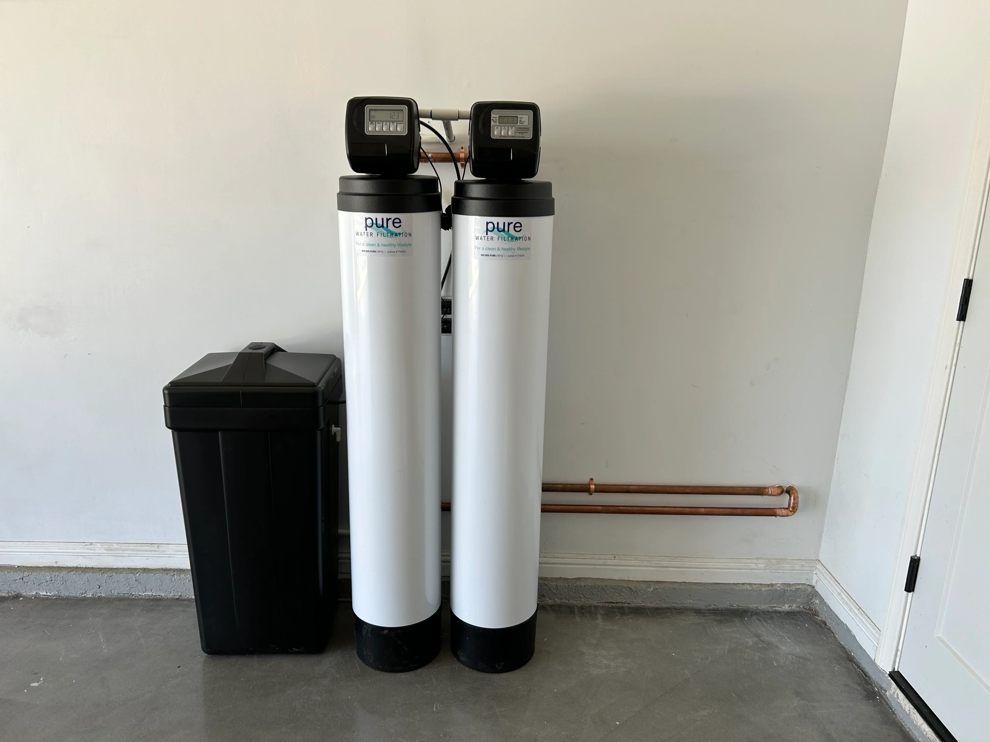 Dual tank water softener and carbon filter system with digital controls and copper piping