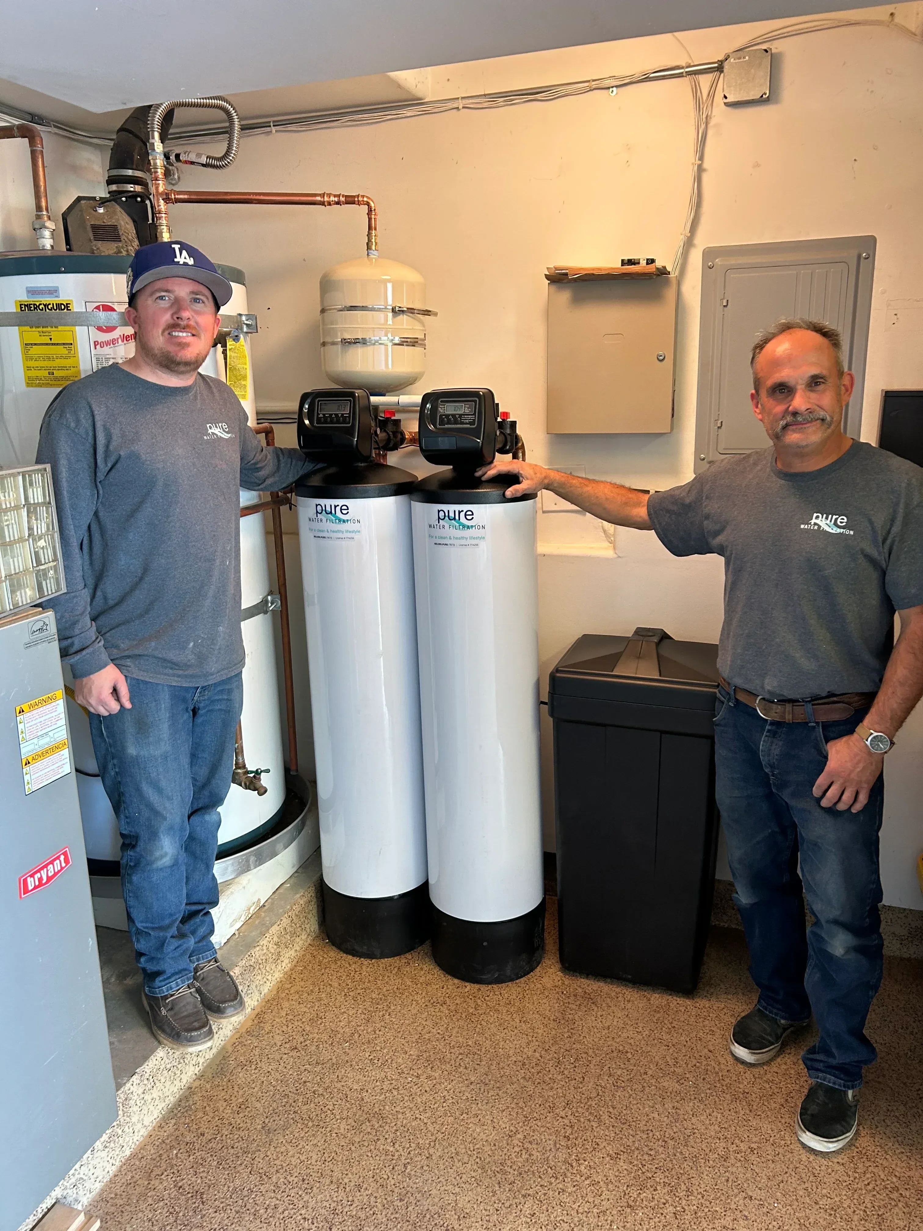 Dual carbon filter cartridges with digital controls and copper piping in utility installation